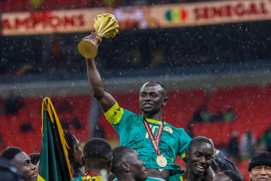 113573740-senegals-forward-10-sadio-mane-holds-up-the-trophy-as-he-celebrates-with-his-teammat